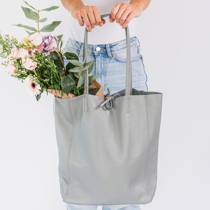 Dove Grey leather tote handbag made from wonderfully soft Italian Leather, with a tie top & long handles to fit comfortably over your shoulder and an Internal leather zip pocket for your valuables. An elegant shopper or work handbag.