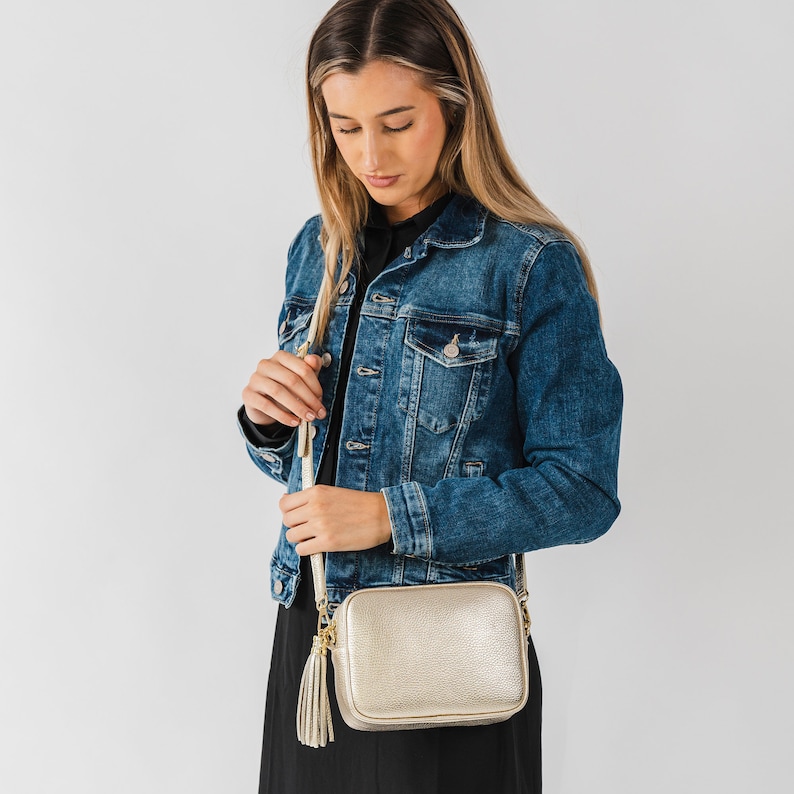 Metallic gold soft pebbled leather ladies box handbag. With gold hardware, tassel close, adjustable strap, use as a crossbody or shoulder bag, detachable straps, fully lined, can be personalised with an engraved disc.