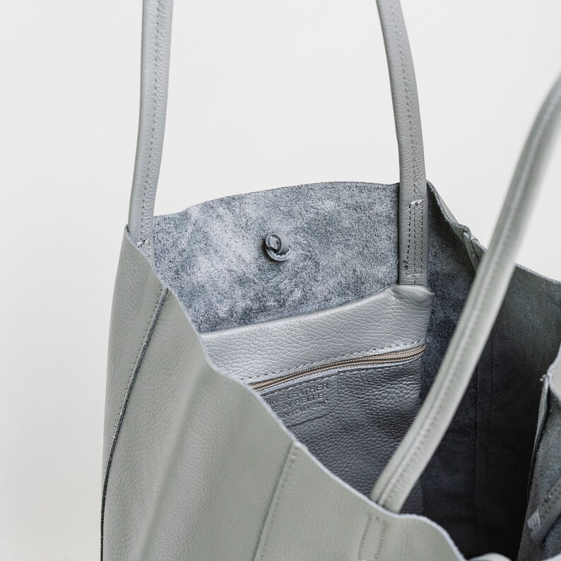 ove Grey leather tote handbag made from wonderfully soft Italian Leather, with a tie top & long handles to fit comfortably over your shoulder and an Internal leather zip pocket for your valuables. An elegant shopper or work handbag.