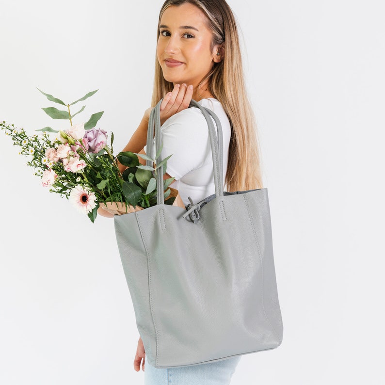 ove Grey leather tote handbag made from wonderfully soft Italian Leather, with a tie top & long handles to fit comfortably over your shoulder and an Internal leather zip pocket for your valuables. An elegant shopper or work handbag.