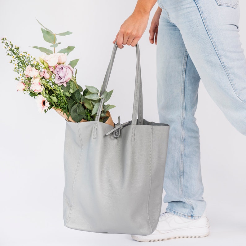 ove Grey leather tote handbag made from wonderfully soft Italian Leather, with a tie top & long handles to fit comfortably over your shoulder and an Internal leather zip pocket for your valuables. An elegant shopper or work handbag.