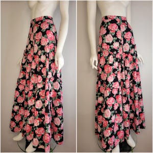 May include: A long black skirt with a pink and green floral print. The skirt has multiple tiers and a high waist.