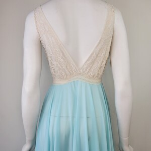 May include: A light blue sheer nightgown with a white lace bodice and a deep V-neckline.