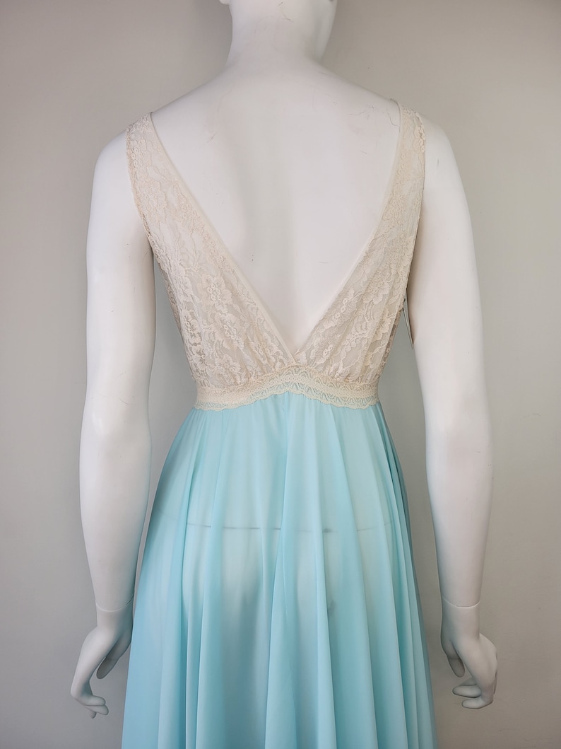 May include: A light blue sheer nightgown with a white lace bodice and a deep V-neckline.