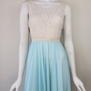 May include: A light blue sleeveless nightgown with a white lace bodice. The gown has a gathered skirt and a fitted bodice.