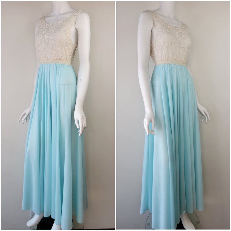 May include: A light blue maxi dress with a white lace bodice. The dress has a fitted bodice and a flowing skirt.