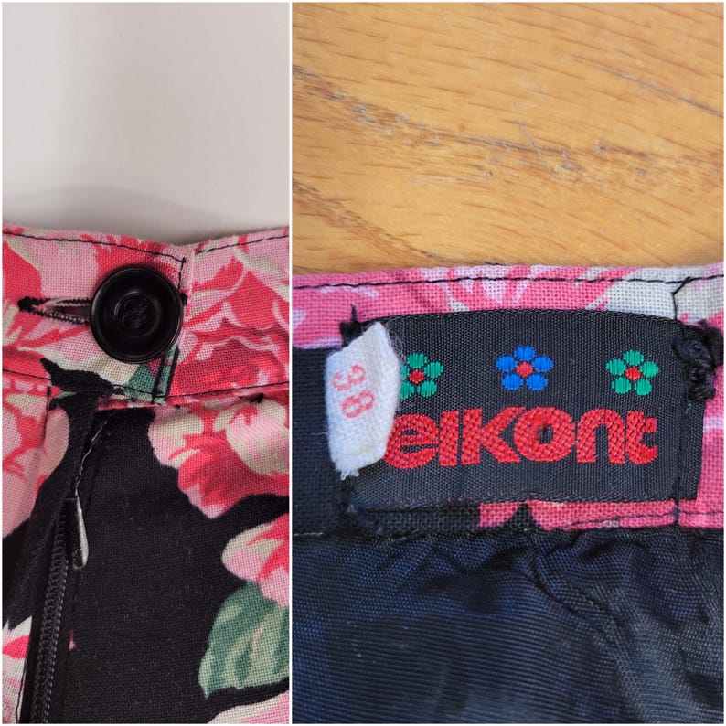 May include: Black skirt with a pink and white floral print. The skirt has a zipper closure and a button at the waist. The skirt has a label that says "elkont" and "38".