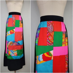 May include: A black skirt with a patchwork design. The skirt is made of different fabrics in various colors, including red, green, blue, pink, and orange. The patchwork design features paisley and geometric patterns.
