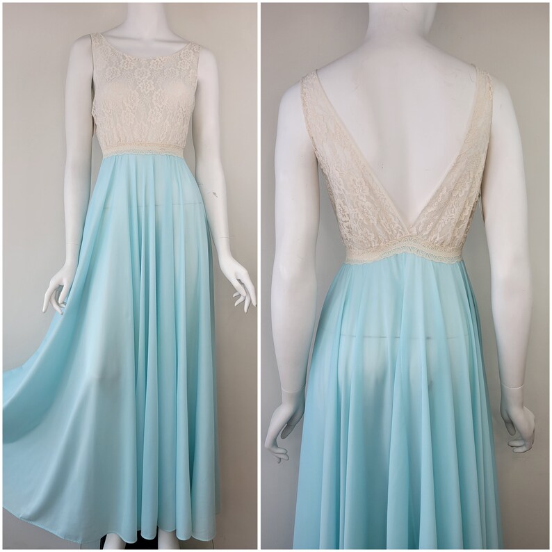 May include: A light blue maxi dress with a white lace bodice. The dress has a scoop neckline and a sleeveless design.