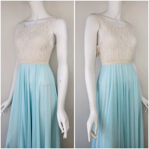 May include: A light blue sleeveless gown with a white lace bodice. The gown has a full skirt and is made of a sheer fabric.