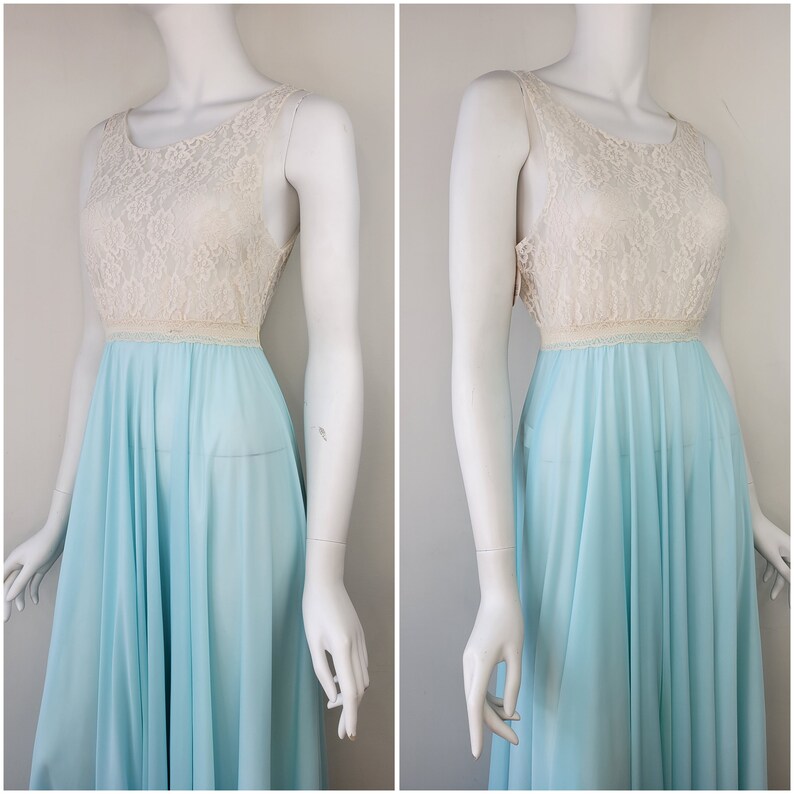 May include: A light blue sleeveless gown with a white lace bodice. The gown has a full skirt and is made of a sheer fabric.