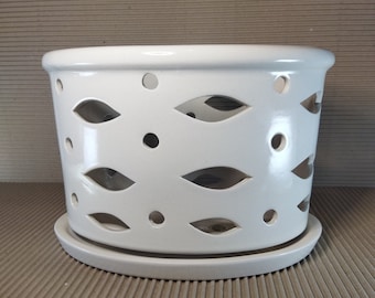 Ceramic plant pot with light slots. On small legs. Glazed inside and outside. A saucer in the set. Set of two pot and saucer.