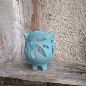 May include: A set of three ceramic mugs with a speckled, matte finish. The mugs are in shades of blue, green, and white. Each mug has a rounded handle and a simple, modern design. The mugs are likely for coffee or tea.