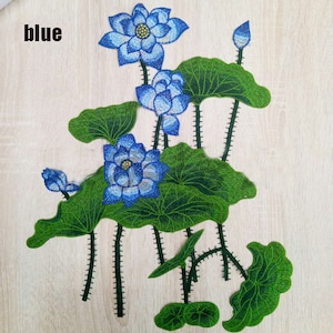 May include: Blue embroidered patch of a lotus flower with green leaves. The patch is labeled "blue".
