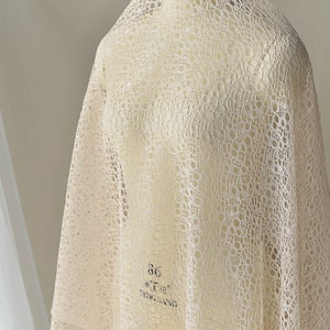 May include: A close-up of a beige lace fabric with a circular pattern. The fabric is draped over a white mannequin. The text "bare color" is printed on the fabric.