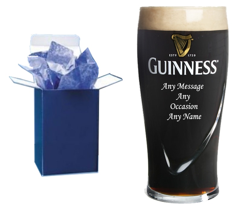 May include: A personalized Guinness pint glass in a blue gift box. The glass has the Guinness logo and the text "ESTD 1759 GUINNESS" printed on it. The text "Any Message Any Occasion Any Name" is also printed on the glass.