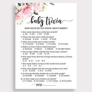 May include: A pink and green floral baby shower trivia game with questions about babies. The questions are printed in black text on a white background. The title of the game is "baby trivia".