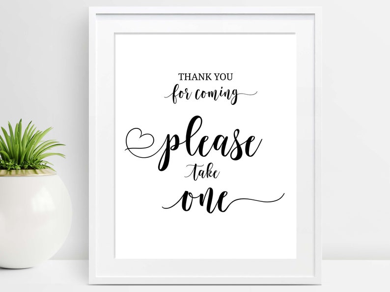 May include: A white framed sign with black text that reads "Thank you for coming please take one". The sign is on a white surface.