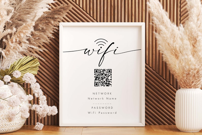 May include: White framed sign with the word "wifi" in cursive script, a black and white QR code, and the text "NETWORK Nelwork Name PASSWORD Wifi Password".