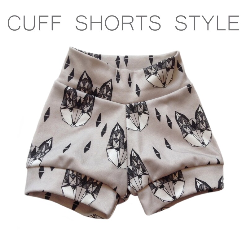 May include: Gray shorts with a geometric fox print. The shorts have a cuffed hem.