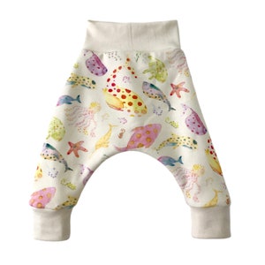 May include: White baby pants with a colorful watercolor print of various sea creatures, including fish, jellyfish, and starfish.