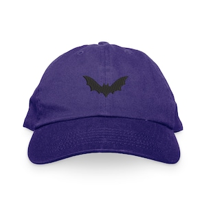 May include: A purple baseball cap with a black embroidered bat silhouette.