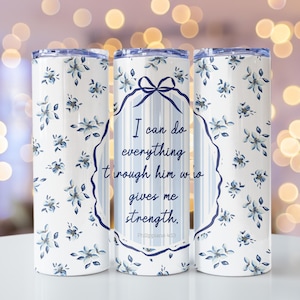 May include: Three stainless steel tumblers with a white background and blue floral pattern. The center tumbler has a blue and white striped background with a quote in a circle: "I can do everything through him who gives me strength. Philippians 4:13"