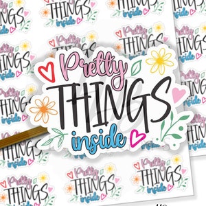 May include: A sticker sheet with multiple colorful stickers featuring the phrase "Pretty Things Inside" with flowers and hearts. The stickers are on a white background.