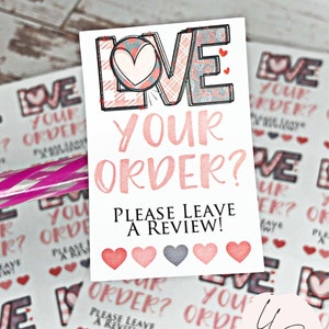 May include: A pink and gray patterned sticker with the text "LOVE YOUR ORDER? PLEASE LEAVE A REVIEW!" and five pink and gray hearts.