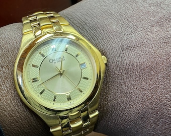 Brand new Mens Caravelle by Bulova gold tone date watch.#1504WB.Free shipping!!!