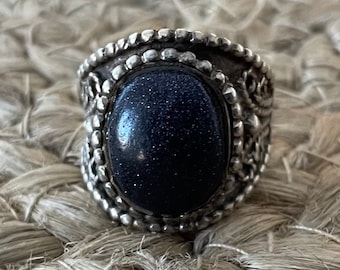 Bold sterling silver ring with unique designs with a blue stone. #1062T2.