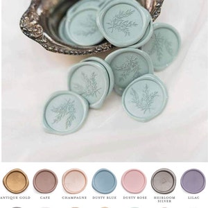May include: A collection of round wax seals in various colours, including antique gold, cafe, champagne, dusty blue, dusty rose, heirloom silver, lilac, lilac grey, linen, antique copper, prosecco, silver sage, vintage rose, and white. Each seal features a delicate floral design.