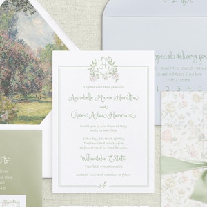 May include: A wedding invitation with a floral design and the names Annabelle Marie Hamilton and Oliver Alan Hammand. The invitation is for a wedding ceremony on Saturday, May 10, 2025 at 4:00 PM at Willowdake Estate in Topsfield, Massachusetts.