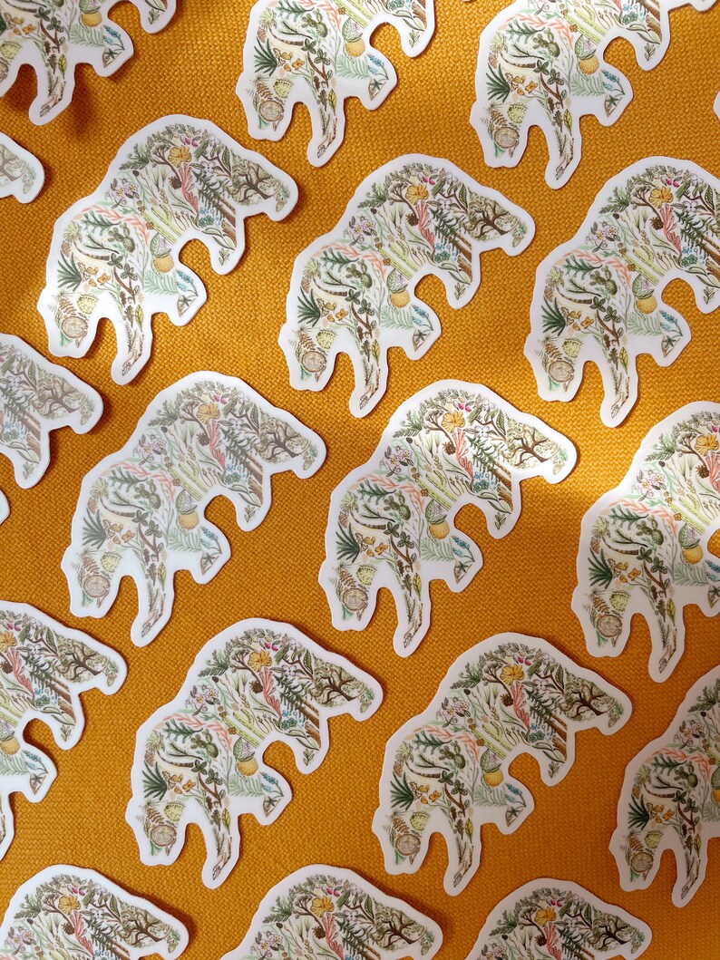 May include: A repeating pattern of white bear-shaped stickers on a yellow background. Each bear is filled with a detailed illustration of various plants, flowers, and leaves in shades of green, brown, yellow, and pink.