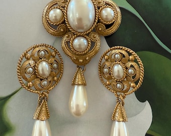 Stunning set of Maltese cross brooch with matching earrings in gold tone metals and faux pearls Signed TAT Classic look