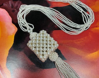 A fun faux pearl square with a tassel long necklace Statement necklace