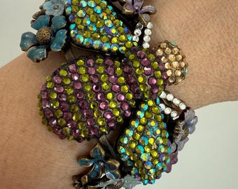 A hinged clamper cuff bracelet is a "To Bee or Not to Bee" by Kirks Folly, featuring a large bee adorned with colorful crystals Statement