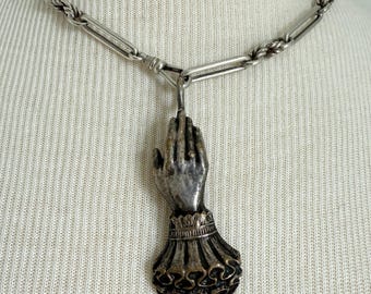 Victorian-style large hand pendant, featuring ornate cuff details and a ring on the finger