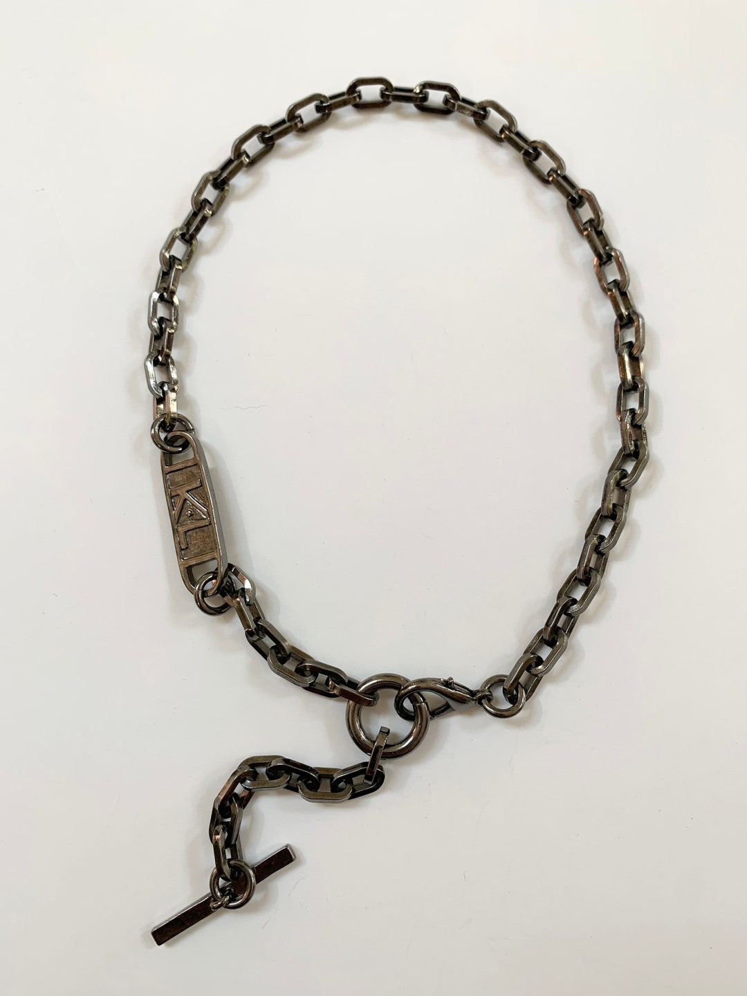 Rare Karl Lagerfeld Logo Necklace In Gun Metal Color With A Toggle And rare-karl-lagerfeld-logo-necklace-in-gun-metal-color-with-a-toggle-and