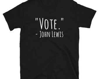 Pode incluir: Camiseta preta com texto branco que diz "VOTE." - JOHN LEWIS.