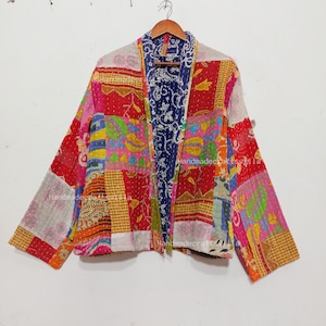 May include: A colorful patchwork jacket with a floral print. The jacket is made of cotton and has a relaxed fit. It is perfect for layering over a shirt or dress.