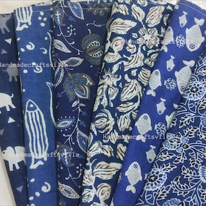 May include: Set of six blue cotton napkins with various indigo block printed designs. The designs include elephants, fish, and floral patterns.