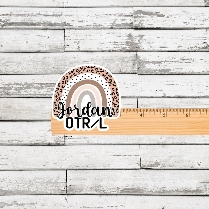 May include: A rainbow sticker with a leopard print design. The rainbow is in shades of brown, pink, and white. The text "Jordan OTR/L" is written below the rainbow.