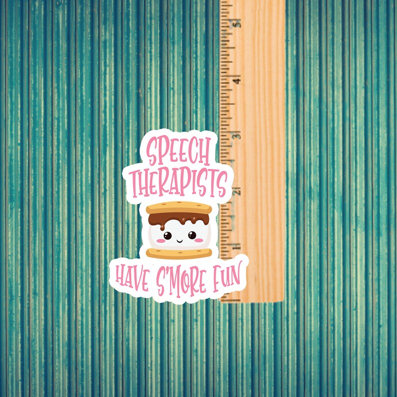 May include: A white sticker with a pink border features a cartoon s'more with a smiling face. The text "Speech Therapists Have S'more Fun" is written in pink letters.