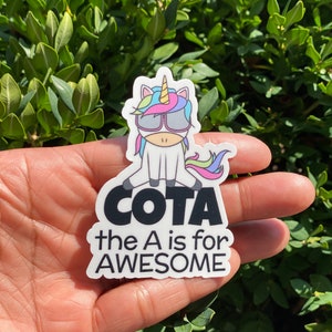 May include: A white unicorn wearing sunglasses and a rainbow mane sits on a white sticker with black text that reads "COTA the A is for AWESOME".