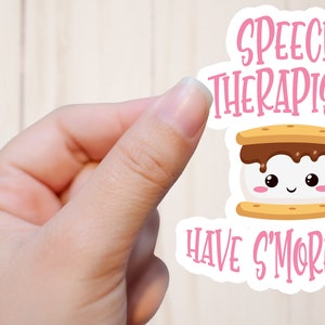 May include: A pink and white sticker with a cartoon s'more and the text "Speech Therapists Have S'more Fun".