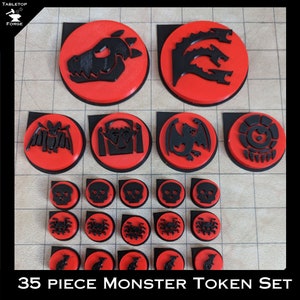 May include: A set of 35 black and red monster tokens for tabletop games. The set includes a variety of monsters, including dragons, bats, skulls, and spiders.