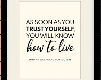 May include: Black framed print with a white background and black text that reads "As soon as you trust yourself, you will know how to live" and "Johann Wolfgang von Goethe". The print is on a brick wall background. The actual frame used for framed prints is 11 x 14 inches and the mat opening is 8 x 10 inches.