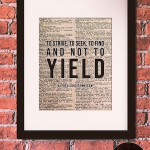 May include: A framed print of a vintage dictionary page with a quote by Alfred Lord Tennyson: "To strive, to seek, to find and not to yield". The print is in a black frame with a white mat.