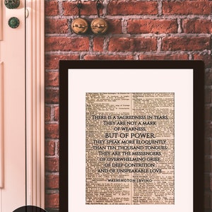 May include: A framed print of a vintage newspaper article with the text "There is a sacredness in tears. They are not a mark of weakness, but of power." The text is attributed to Washington Irving.